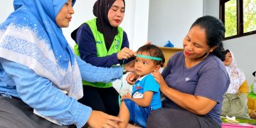 Pengukuran lingkar kepala oleh kader posyandu didampingi tim CD RAPP untuk memantau pertumbuhan dan perkembangan pada anak.